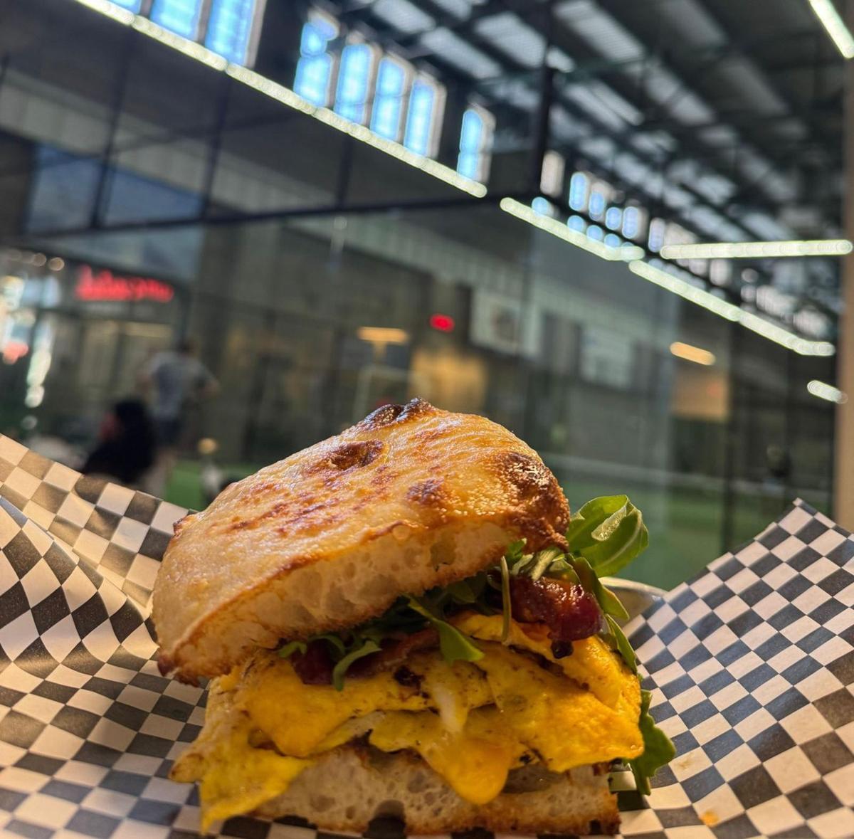 Breakfast sandwich with the padel courts behind